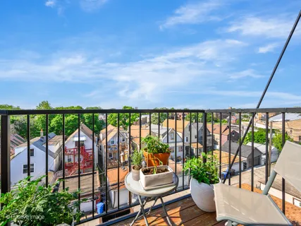 a view of a balcony with furniture and a potted plant