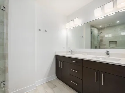 a bathroom with a double vanity sink and mirror