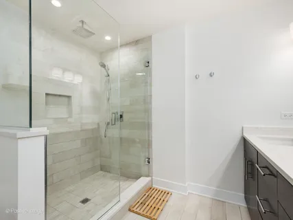 a bathroom with a shower and a sink