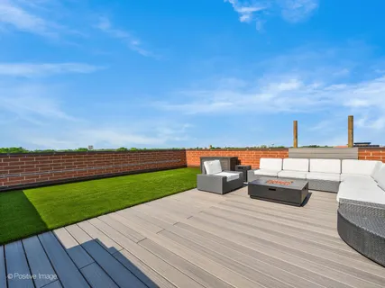 a view of a terrace with wooden floor and seating space