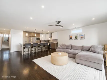 a living room with lots of furniture and wooden floor