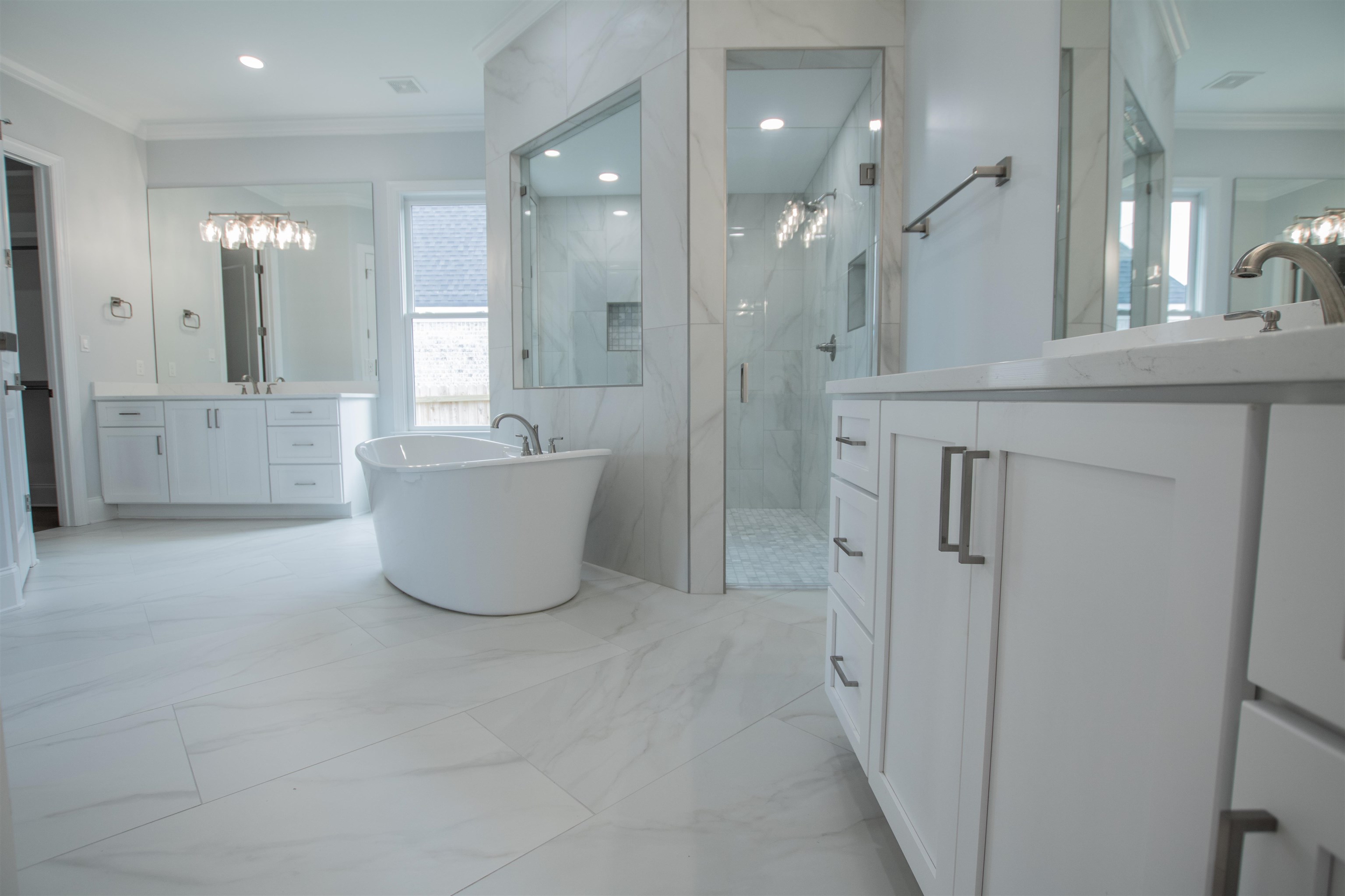 2611 Moore Road Germantown, TN 38138 - Photo 30 of 40 a bathroom with a tub sink shower and mirror