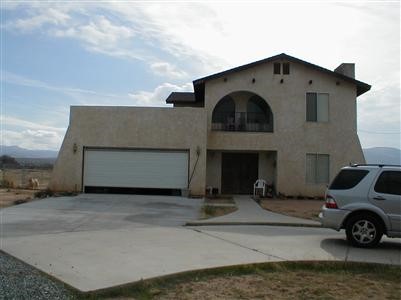 23218 Viento Road Apple Valley, CA 92308 - Photo 1 of 1 a front view of a house with garage