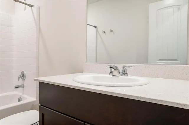 a bathroom with a sink a toilet and a bathtub
