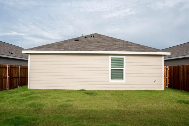 a front view of house with yard and garage