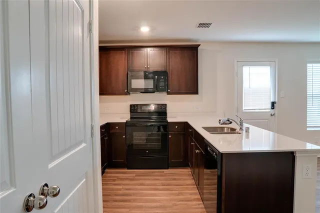 a kitchen with a sink and a refrigerator