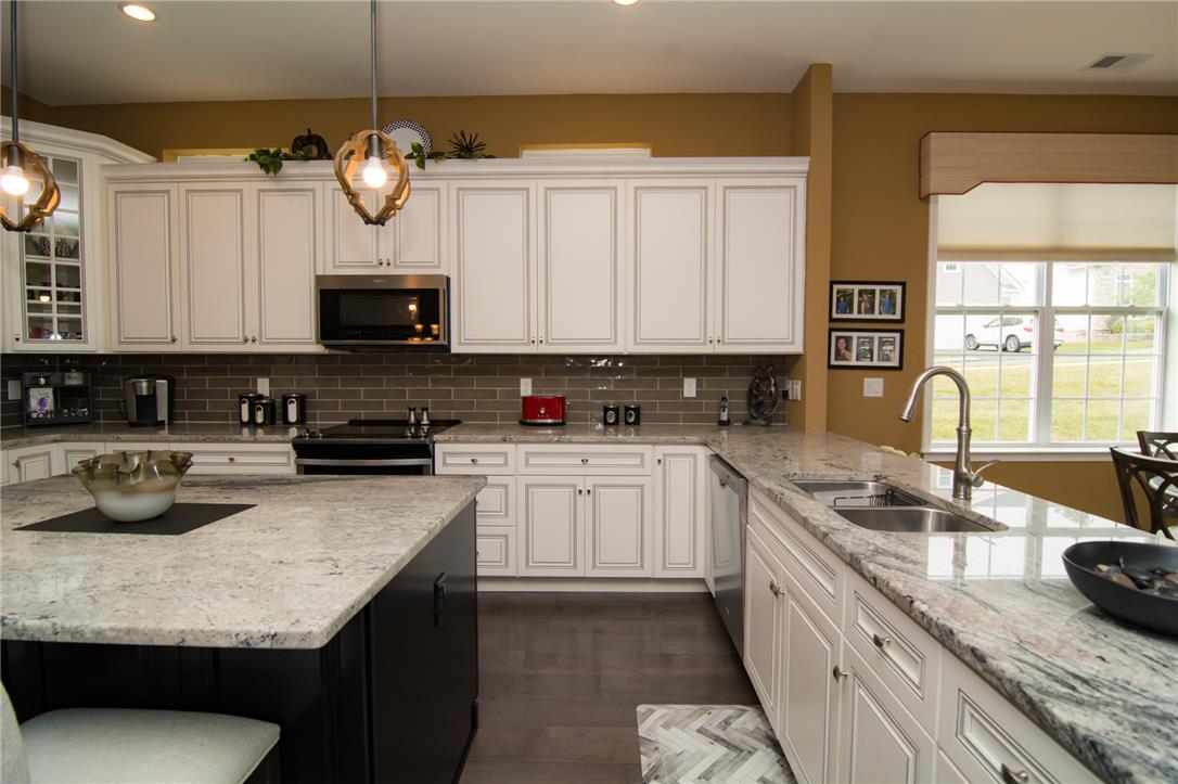4097 Rutz Lane Allentown, PA 18104 - Photo 11 of 59 Polished granite countertops and classic cabinetry anchor this well-appointed kitchen workspace.