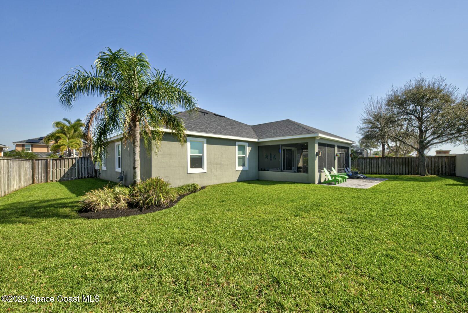 3758 Hollisten Circle Melbourne, FL 32940 - Photo 45 of 51 Backyard Facing West Sideyard & Home