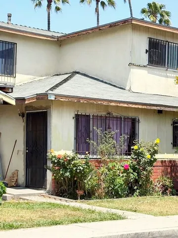 a view of a house with potted plants