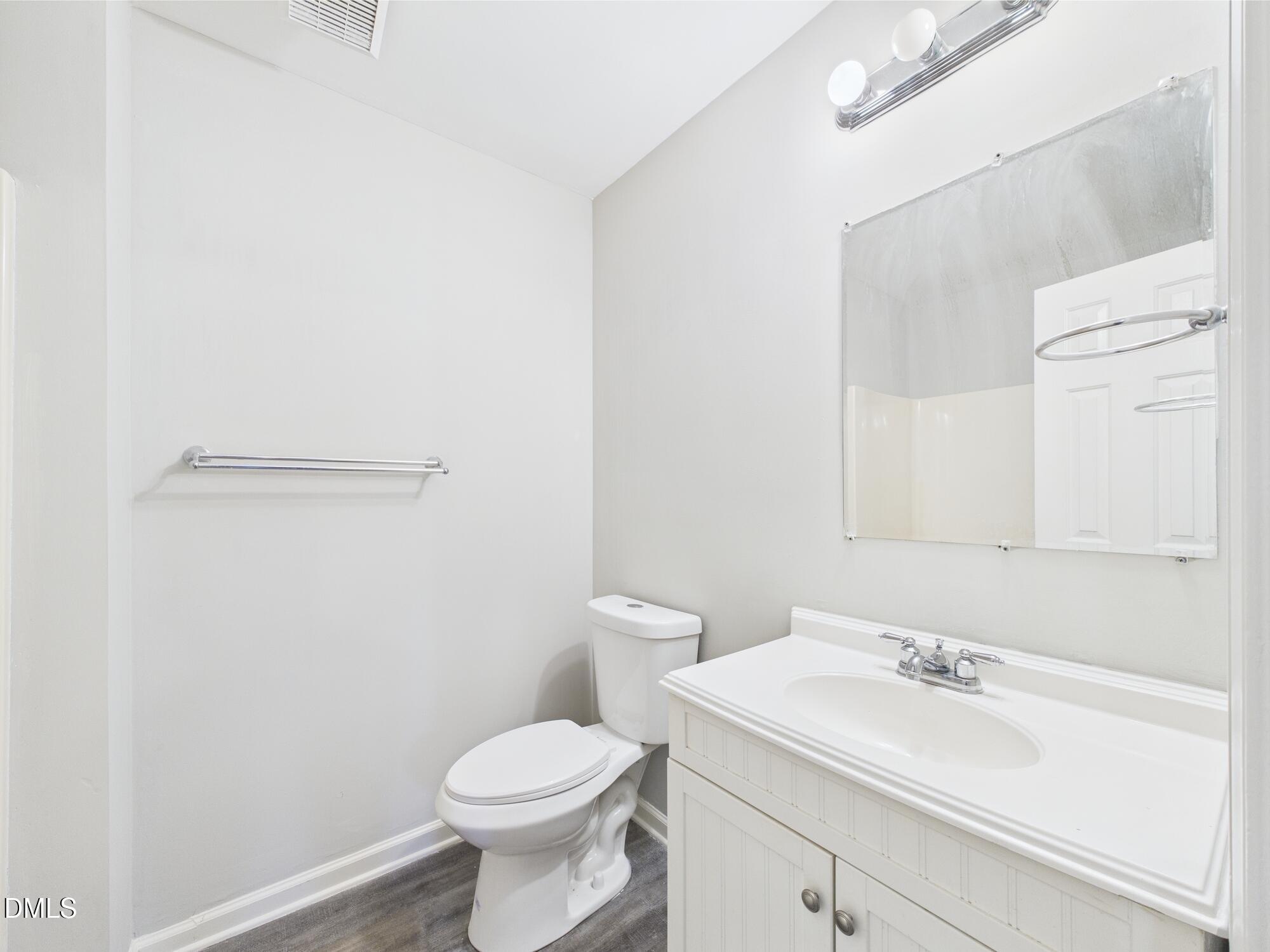 10917 Fanny Brown Road Raleigh, NC 27603 - Photo 36 of 54 a bathroom with a sink a toilet and a mirror
