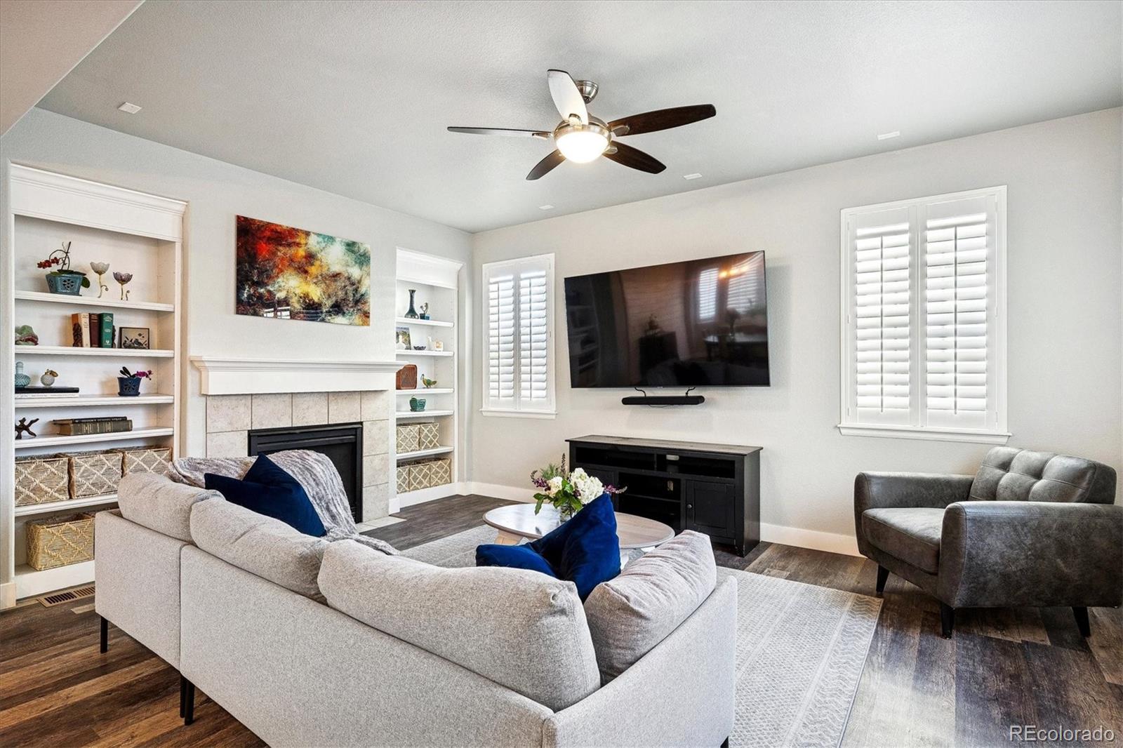 4488 Grapevine Way Castle Rock, CO 80109 - Photo 11 of 46 a living room with fireplace furniture and a flat screen tv