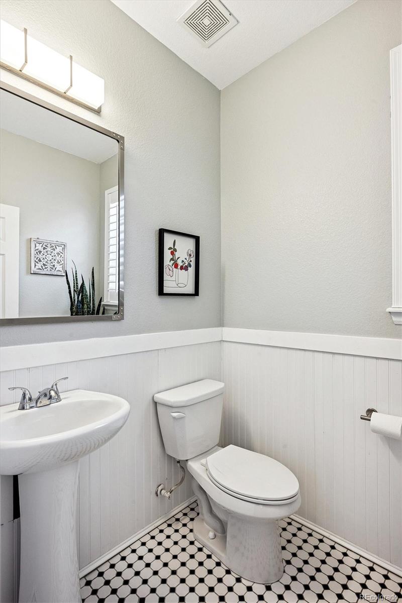 4488 Grapevine Way Castle Rock, CO 80109 - Photo 15 of 46 a bathroom with a toilet a sink and mirror