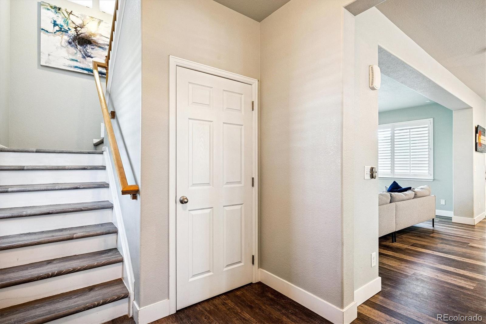 4488 Grapevine Way Castle Rock, CO 80109 - Photo 16 of 46 a view of a hallway with wooden floor and entryway