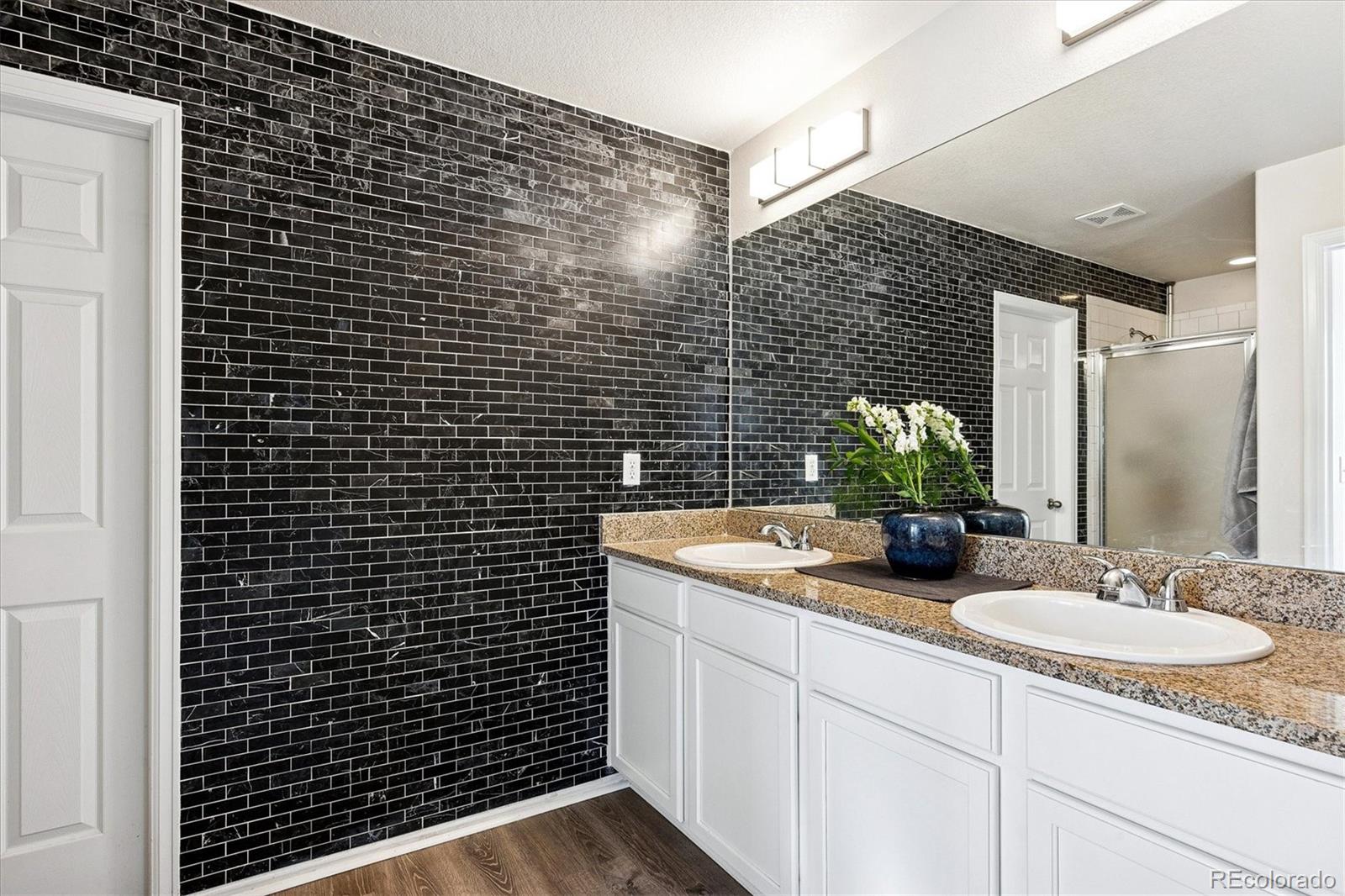 4488 Grapevine Way Castle Rock, CO 80109 - Photo 20 of 46 a bathroom with a sink and a mirror