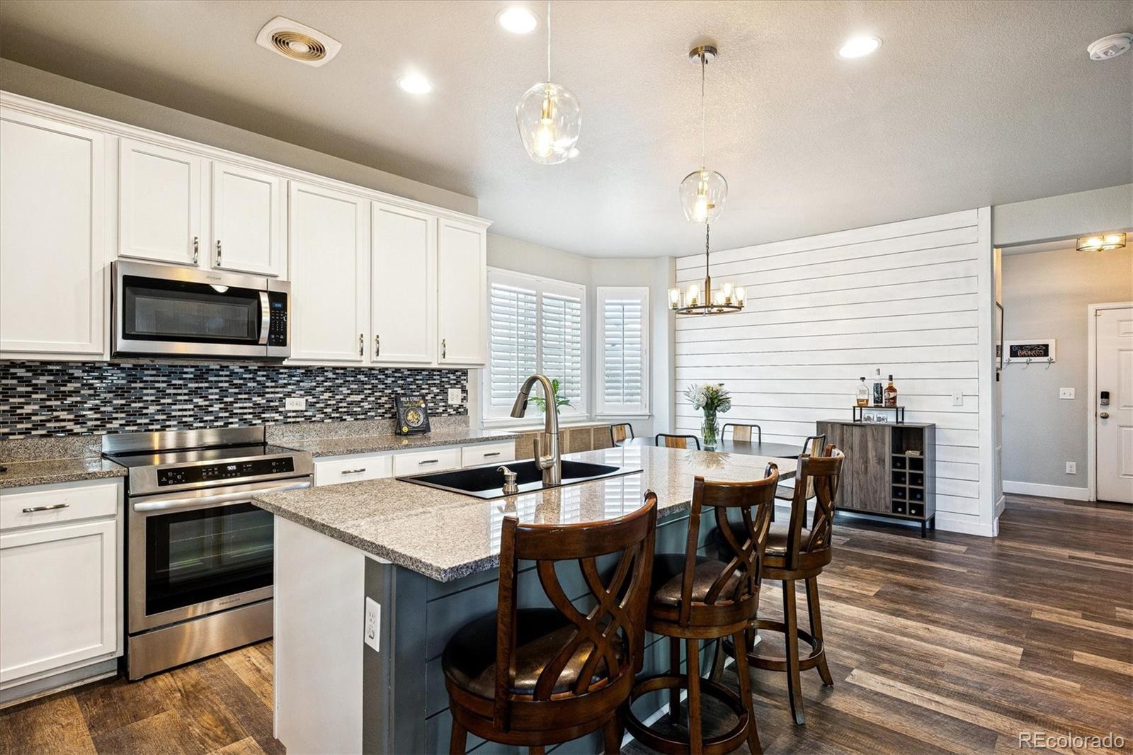 4488 Grapevine Way Castle Rock, CO 80109 - Photo 8 of 46 a kitchen that has a table and chairs in it