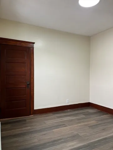 a view of an empty room and wooden floor