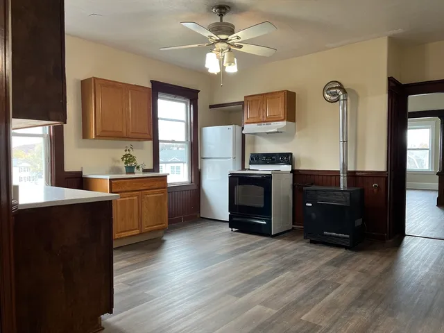 a kitchen with stainless steel appliances a stove top oven and a refrigerator