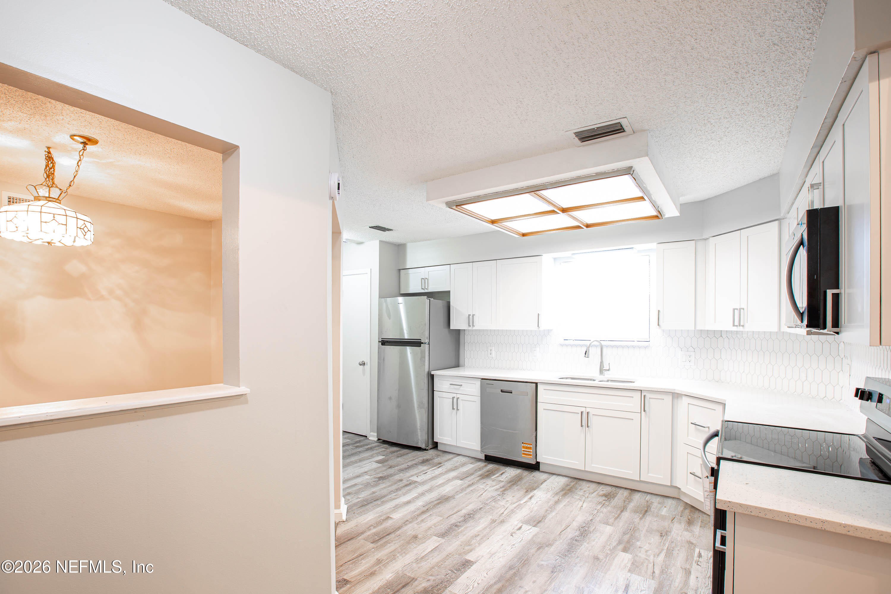 14863 Yellow Bluff Road Jacksonville, FL 32226 - Photo 11 of 48 a kitchen with white cabinets and white appliances