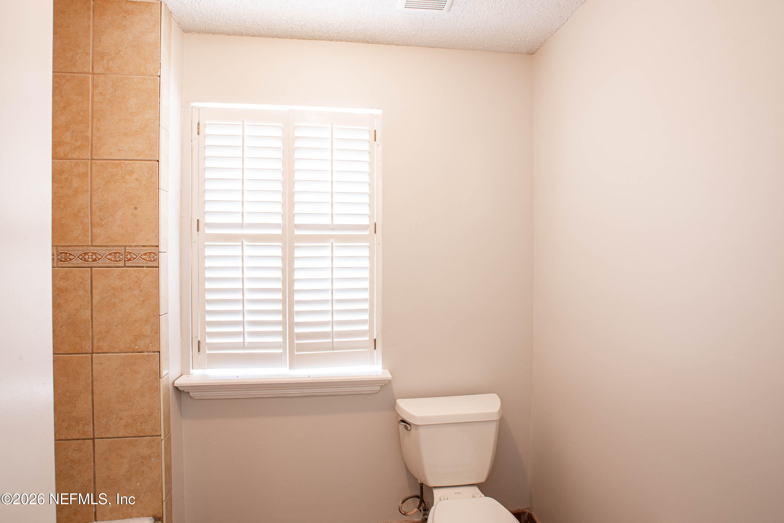 14863 Yellow Bluff Road Jacksonville, FL 32226 - Photo 24 of 48 a bathroom with a toilet a sink and a window
