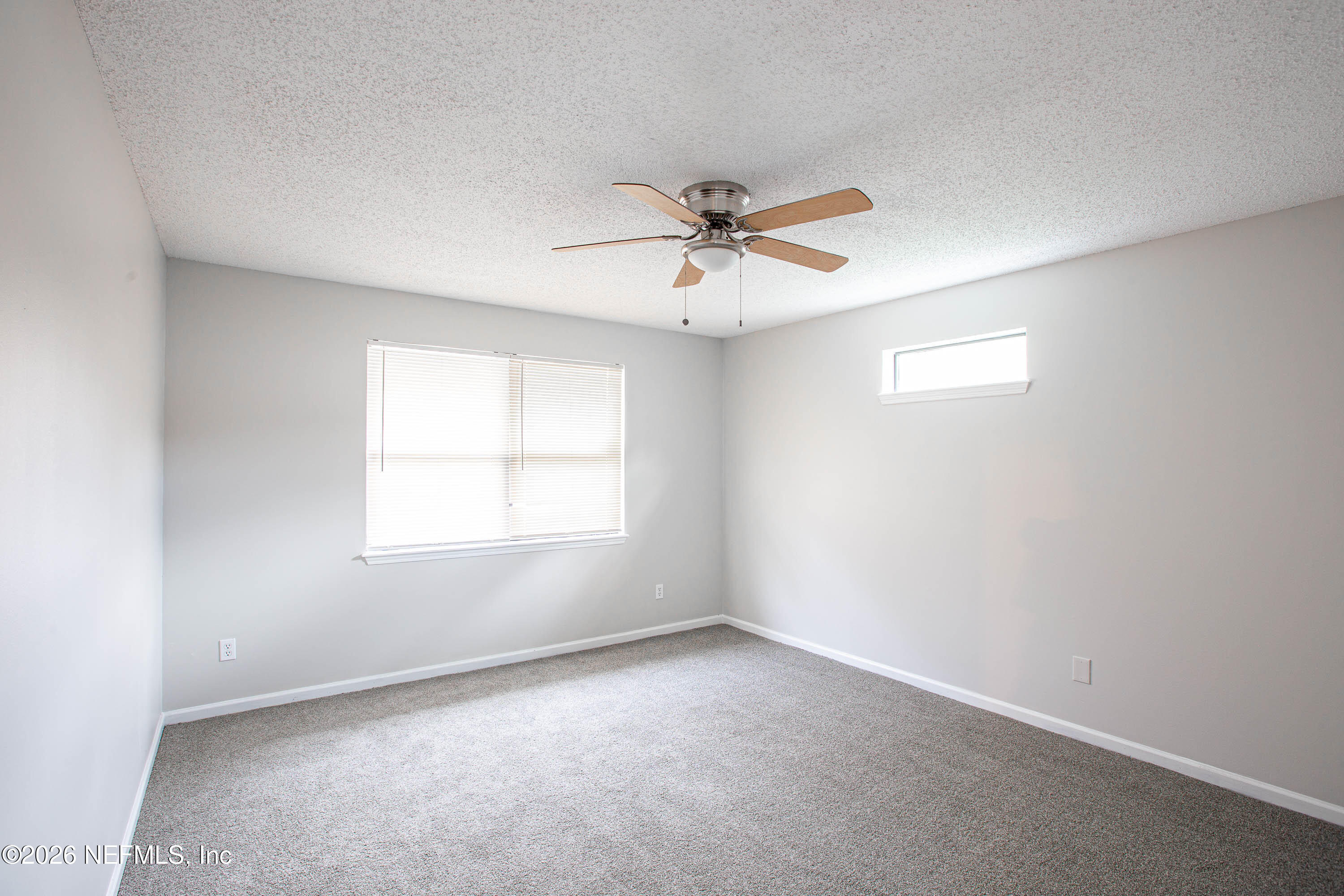14863 Yellow Bluff Road Jacksonville, FL 32226 - Photo 26 of 48 an empty room with a window and a fan