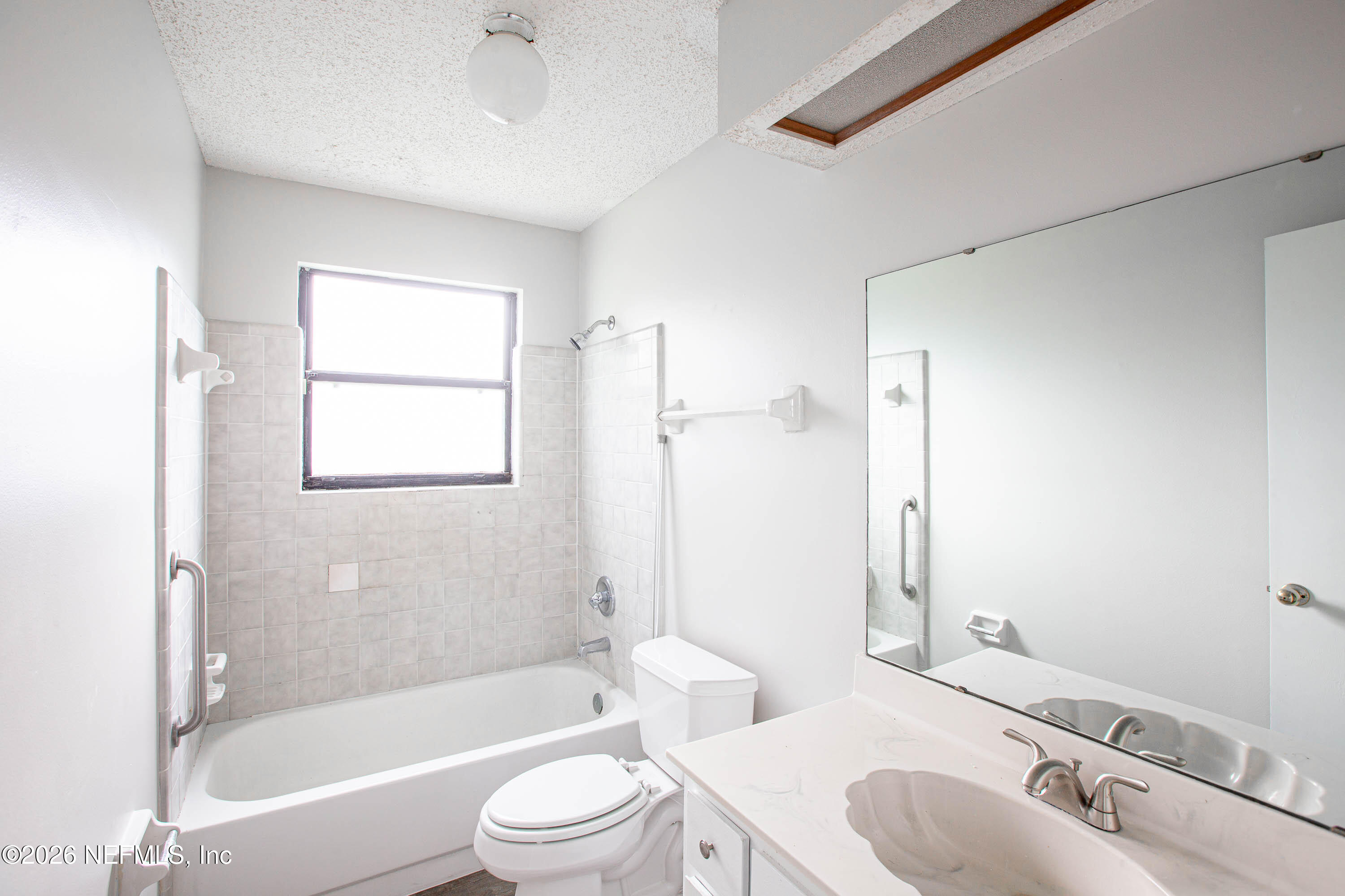 14863 Yellow Bluff Road Jacksonville, FL 32226 - Photo 28 of 48 a bathroom with a bathtub shower sink vanity mirror and toilet