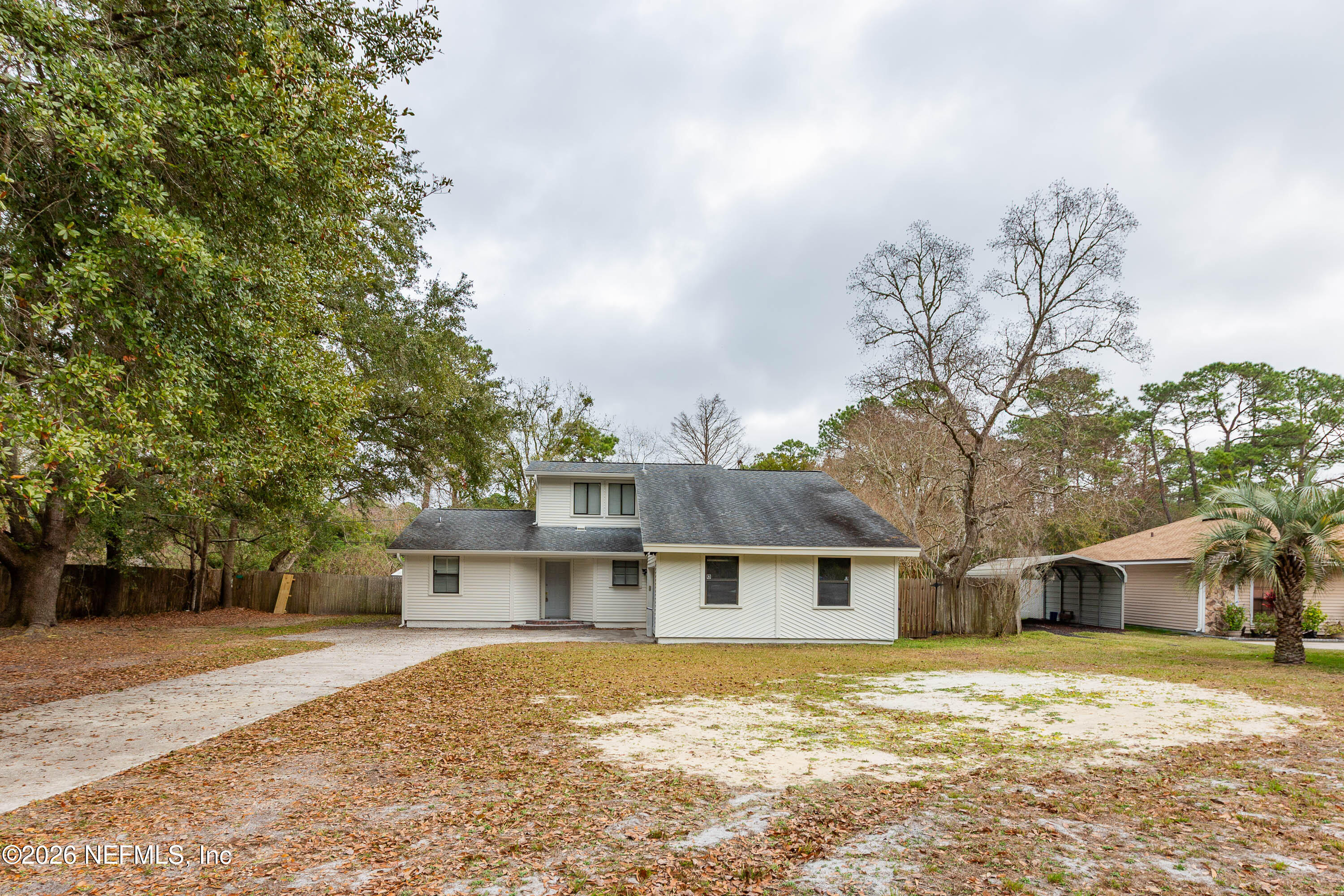 14863 Yellow Bluff Road Jacksonville, FL 32226 - Photo 4 of 48 a front view of a house with a yard covered with trees