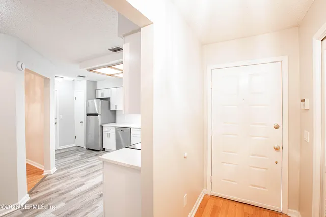a kitchen with appliances a sink and a microwave