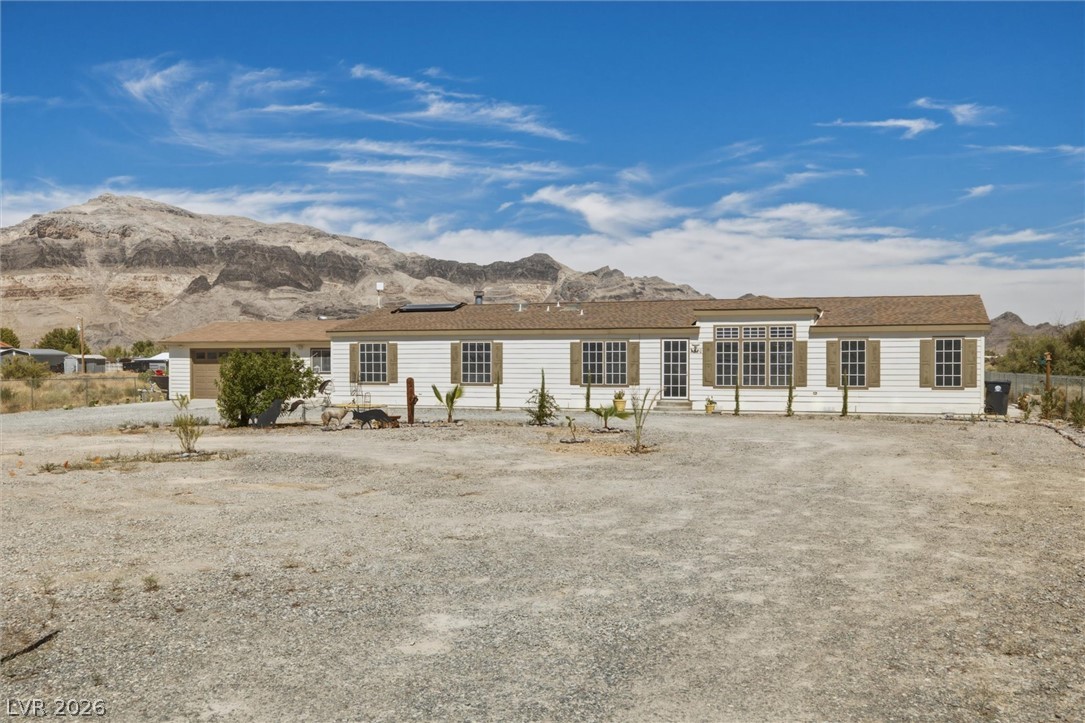 Dramatic mountain vistas frame this sprawling single-level residence nestled on a generous desert parcel.