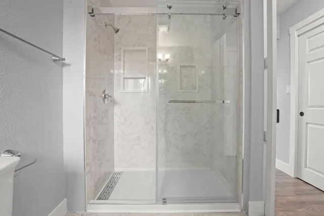 a bathroom with a glass shower door