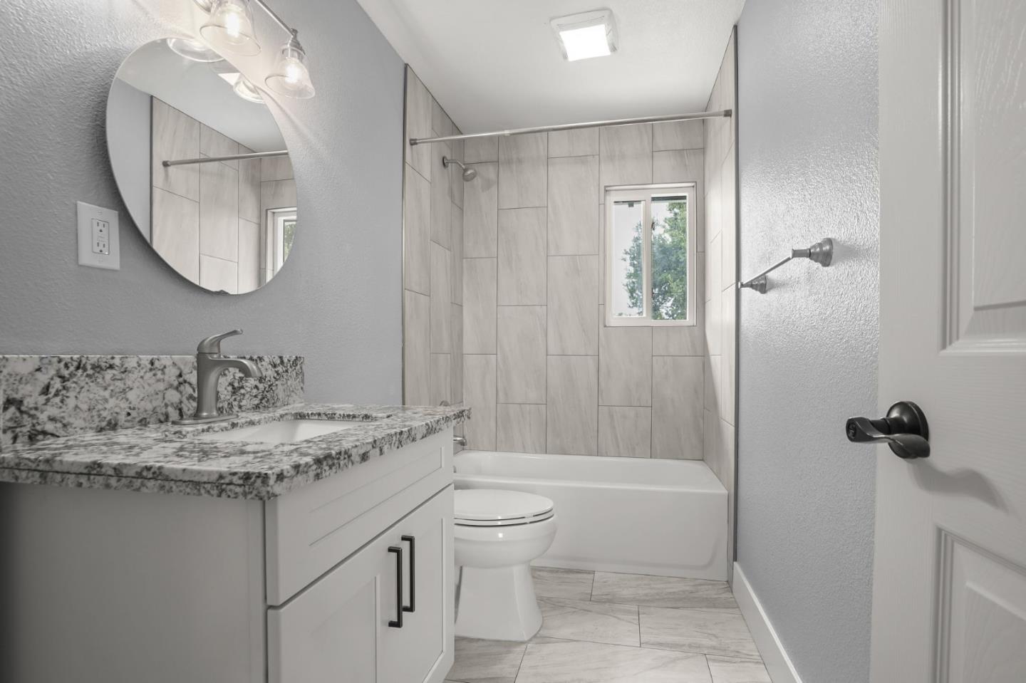 2510 Redwood Road Napa, CA 94558 - Photo 21 of 29 a bathroom with a granite countertop sink a toilet and a mirror