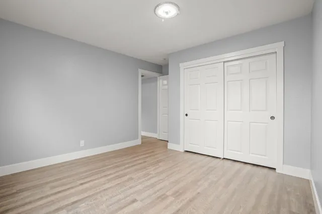 a view of an empty room and wooden floor