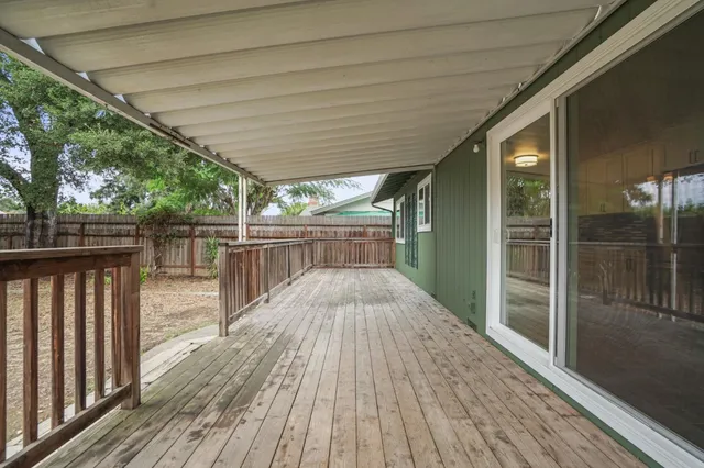 a view of backyard with wooden floor and outdoor seating