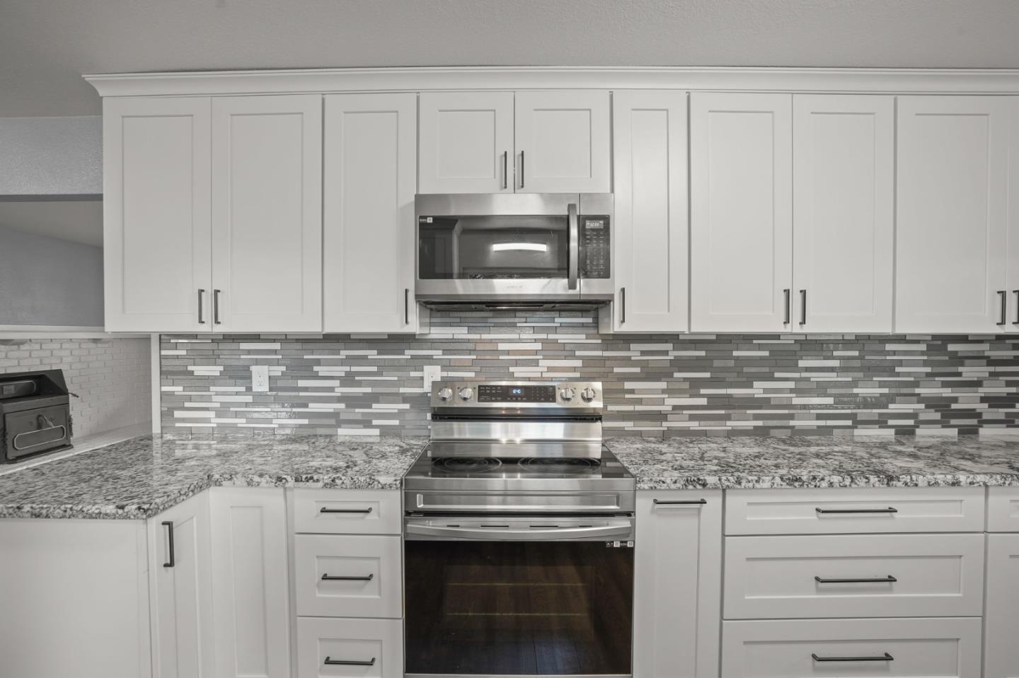 2510 Redwood Road Napa, CA 94558 - Photo 9 of 29 a kitchen with granite countertop white cabinets and stainless steel appliances