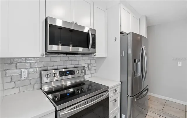 a kitchen with stainless steel appliances a refrigerator stove and microwave