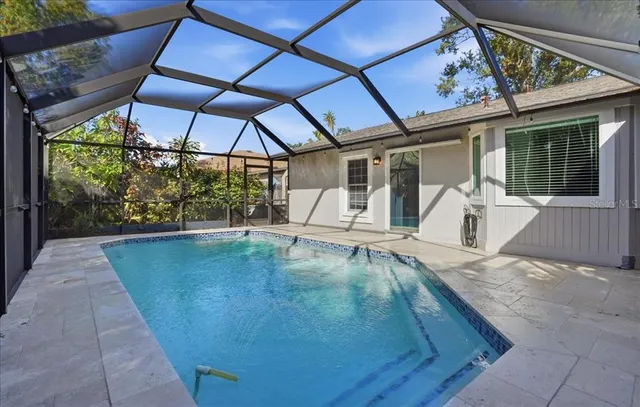 a view of a patio with a table and chairs under an umbrella