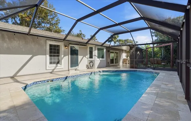 a view of a patio with table and chairs under an umbrella