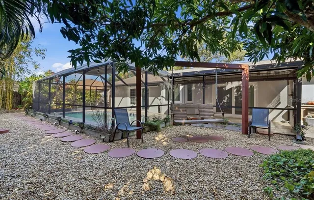 a view of a backyard with a table and chair fire pit and wooden fence