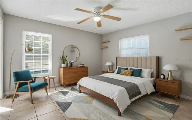 a bedroom with a bed a chair and a window