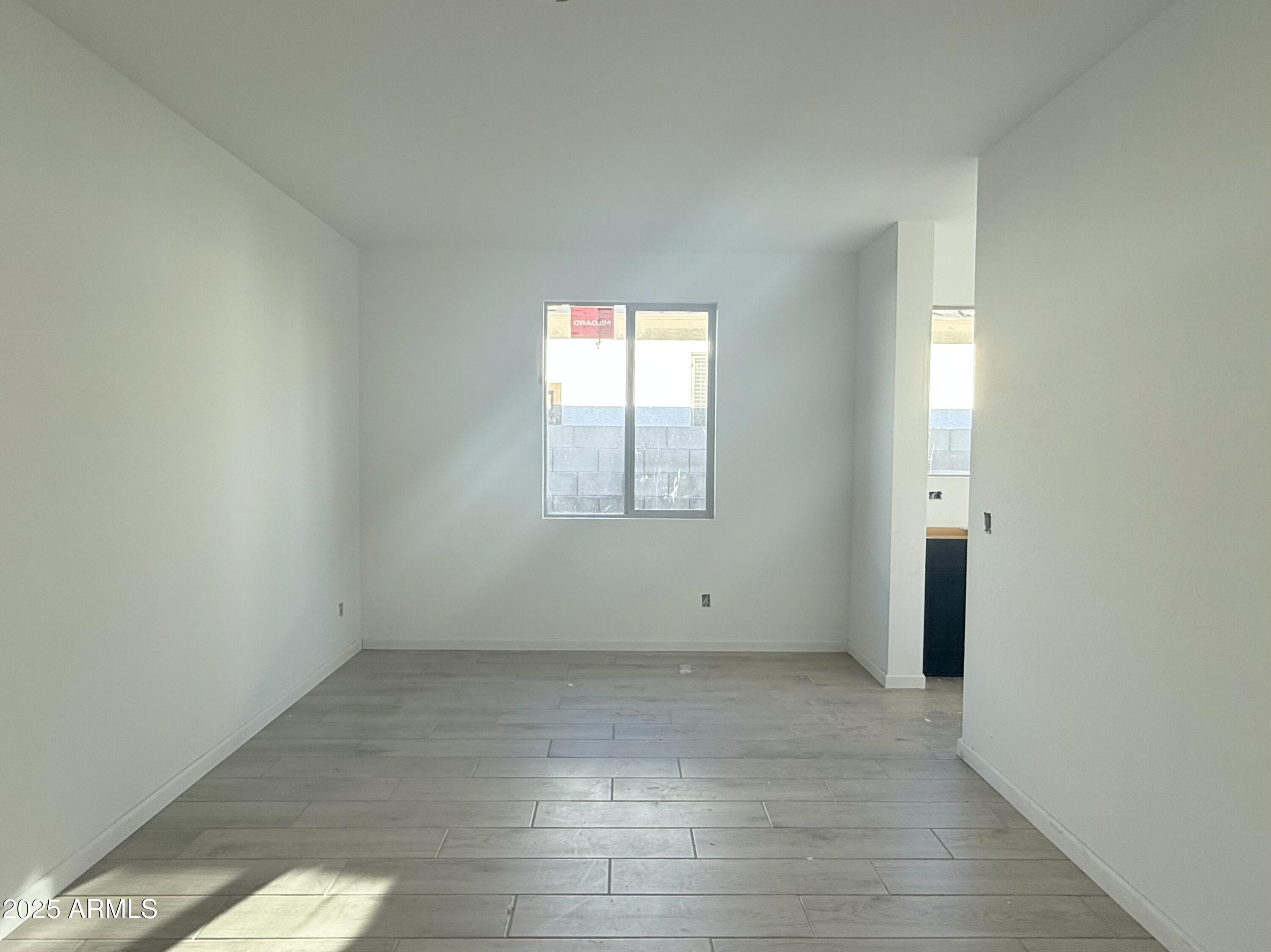 2655 Rustler Road San Tan Valley, AZ 85140 - Photo 12 of 47 an empty room with wooden floor and windows