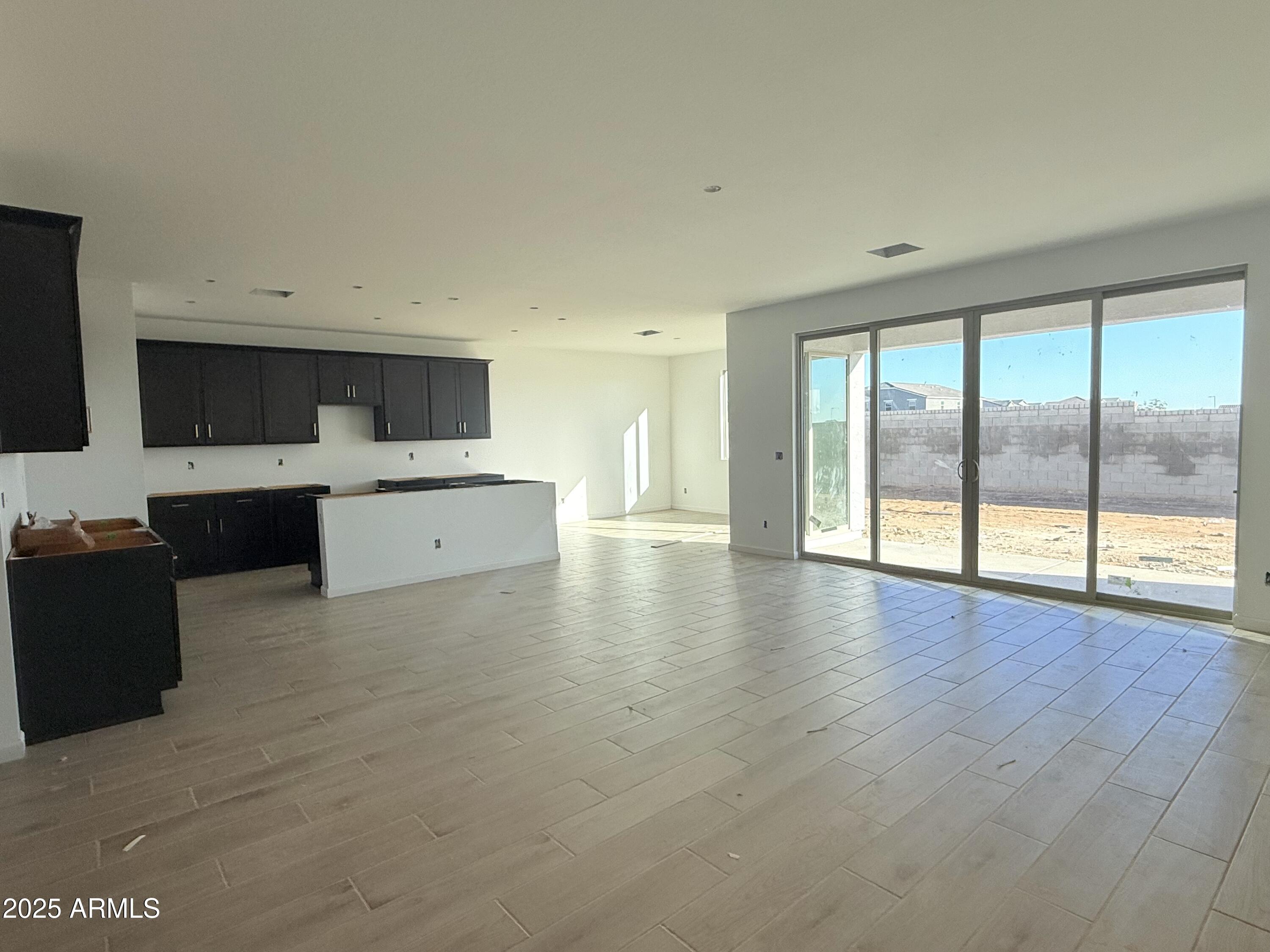 2655 Rustler Road San Tan Valley, AZ 85140 - Photo 14 of 47 a living room with stainless steel appliances kitchen island granite countertop a stove top oven a sink with dishwasher and cabinets