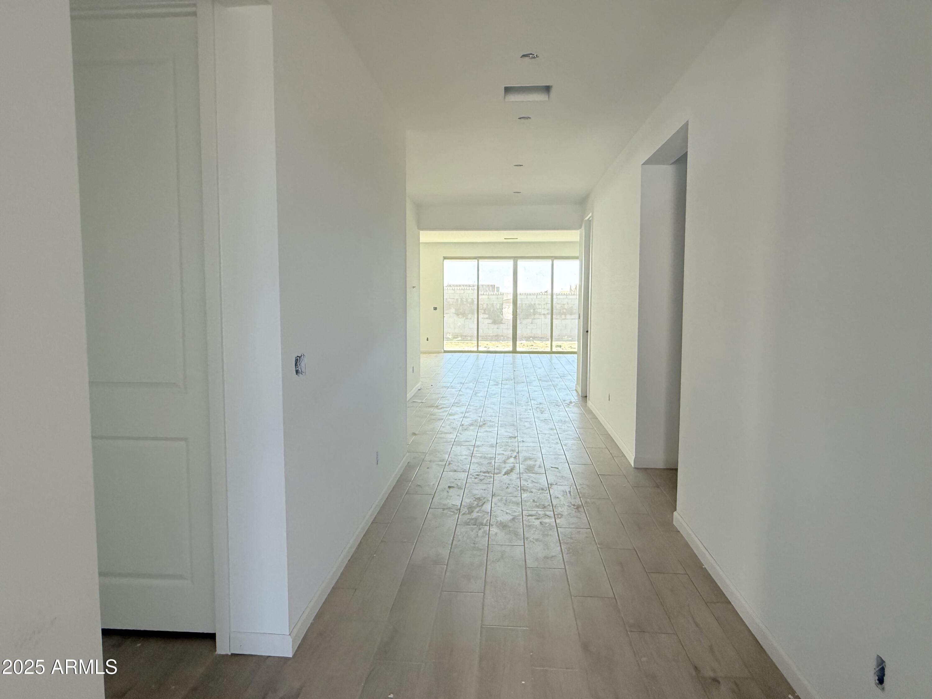 2655 Rustler Road San Tan Valley, AZ 85140 - Photo 4 of 47 a view of a hallway with wooden floor