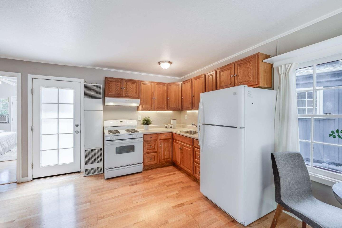 2513 Alpine Road Menlo Park, CA 94025 - Photo 28 of 41 a kitchen with a refrigerator a stove top oven a sink and dishwasher with wooden floor