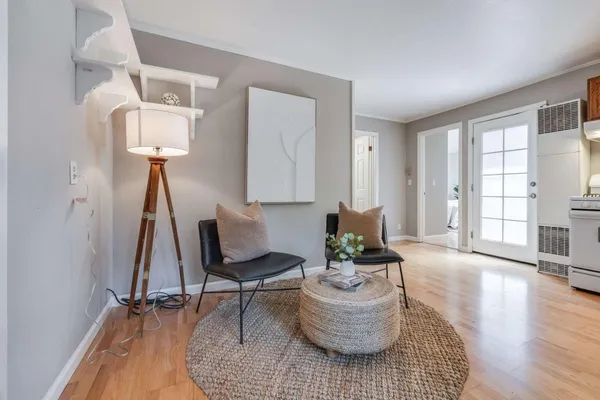 a living room with furniture and a wooden floor