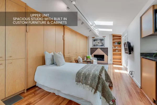 a bedroom with a bed and a large window