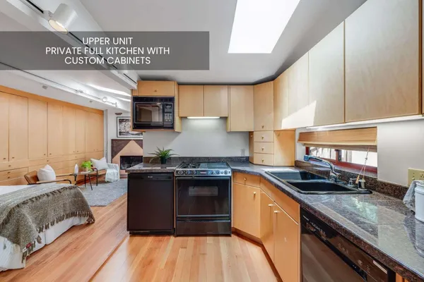 a kitchen with stainless steel appliances granite countertop a stove a sink and a microwave