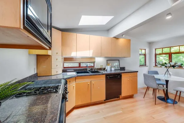 a kitchen with stainless steel appliances granite countertop sink stove top oven and cabinets