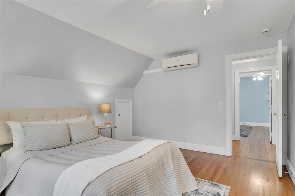 16 Roundwood Road Newton, MA 02464 - Photo 23 of 41 a bedroom with a bed and wooden floor