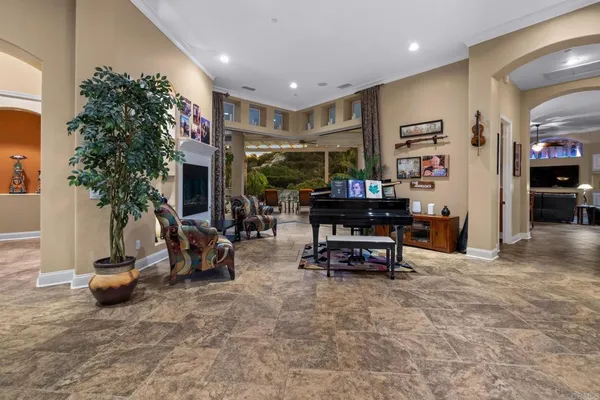 a view of a hallway to a livingroom with furniture and front door
