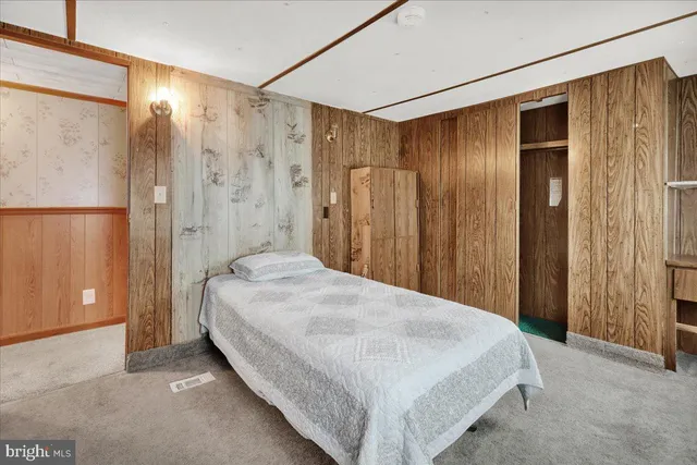 a spacious bedroom with a bed and a shower