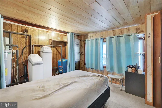 a bed room with a bed and a large mirror